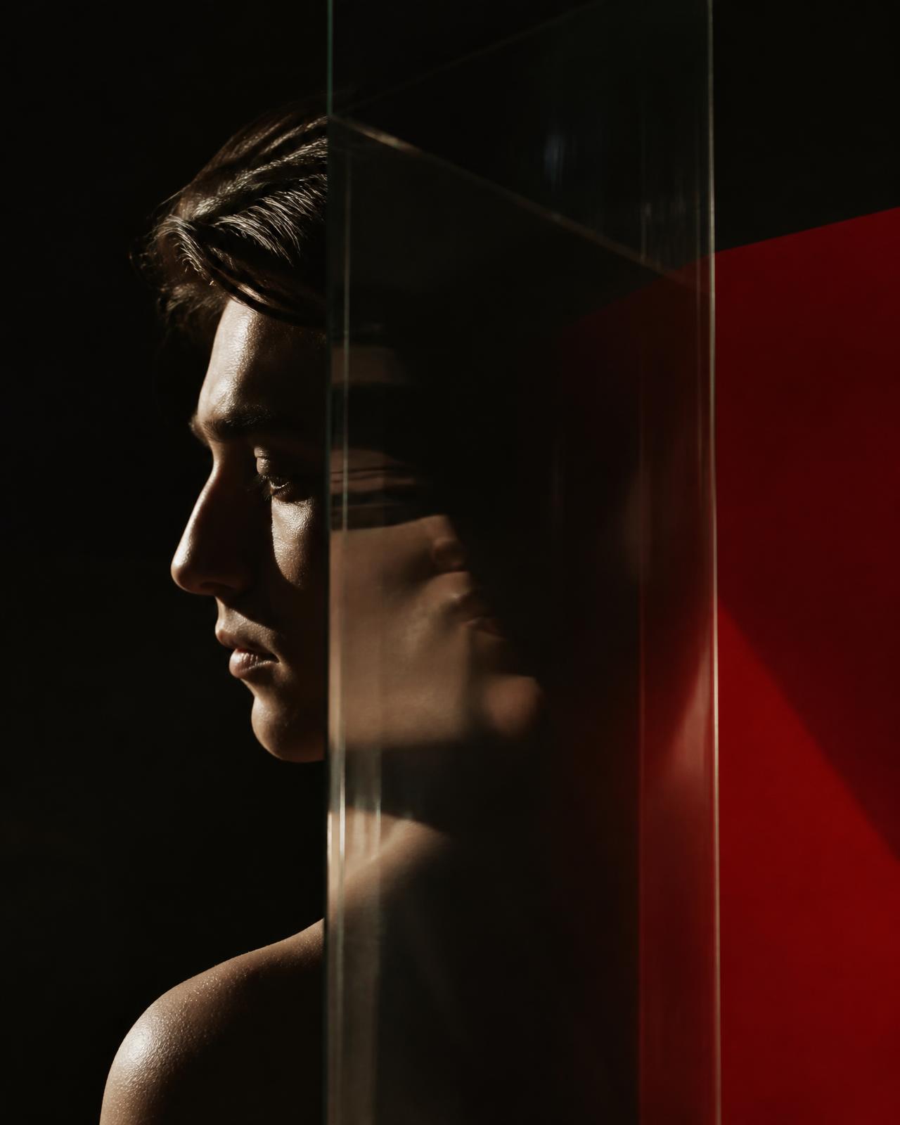 A person seen through layered glass, representing an evolving view of the self